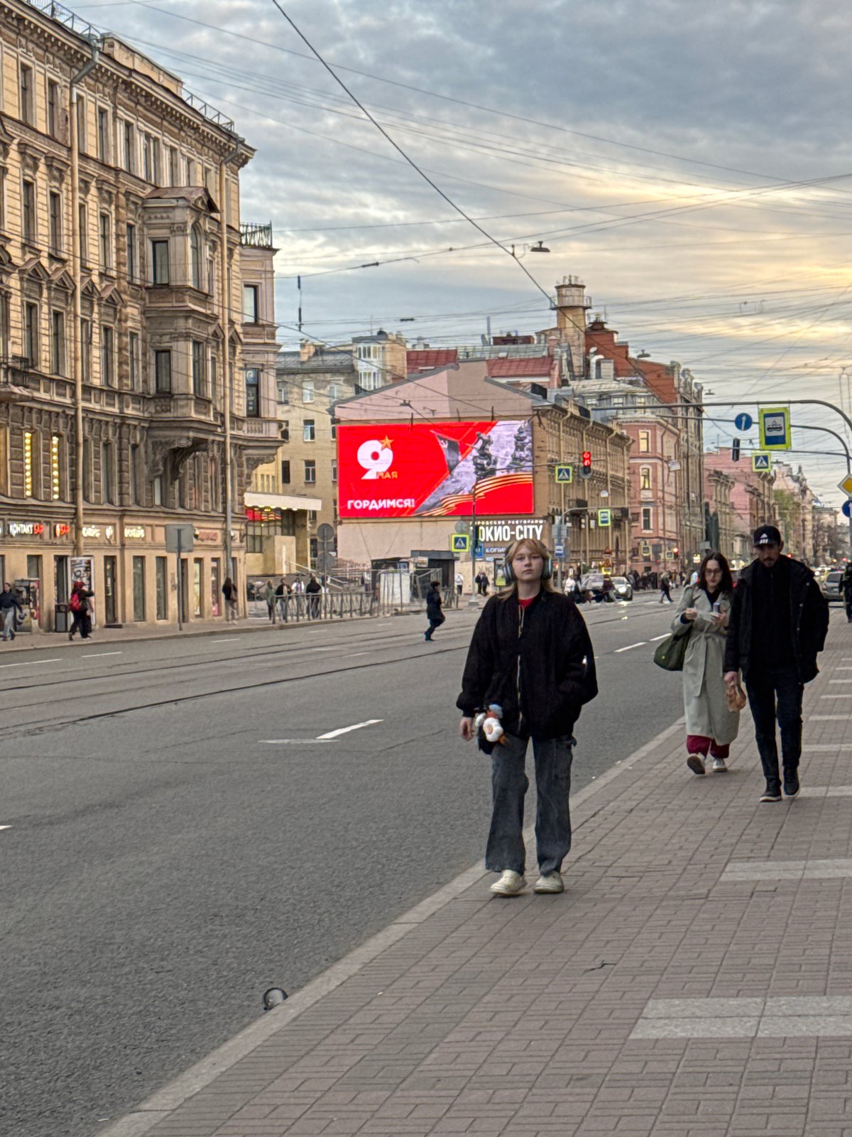 Pedestrians walk Saint Petersburg streets amid historic architecture