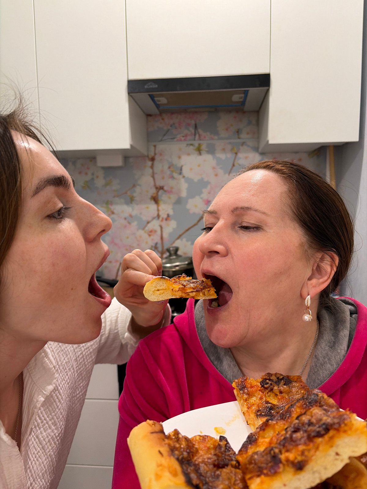 Women share homemade meal in Neftekamsk kitchen
