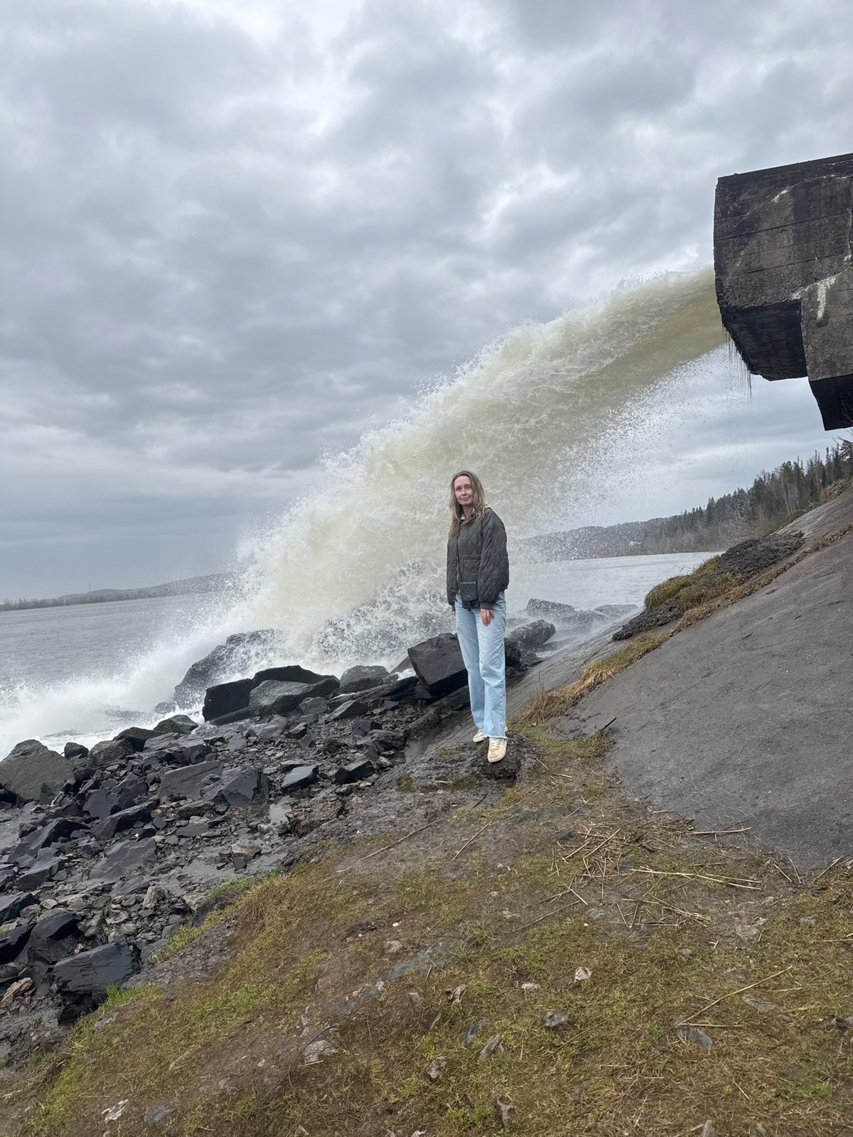 Woman poses by waterfall in Chernushka, Russia