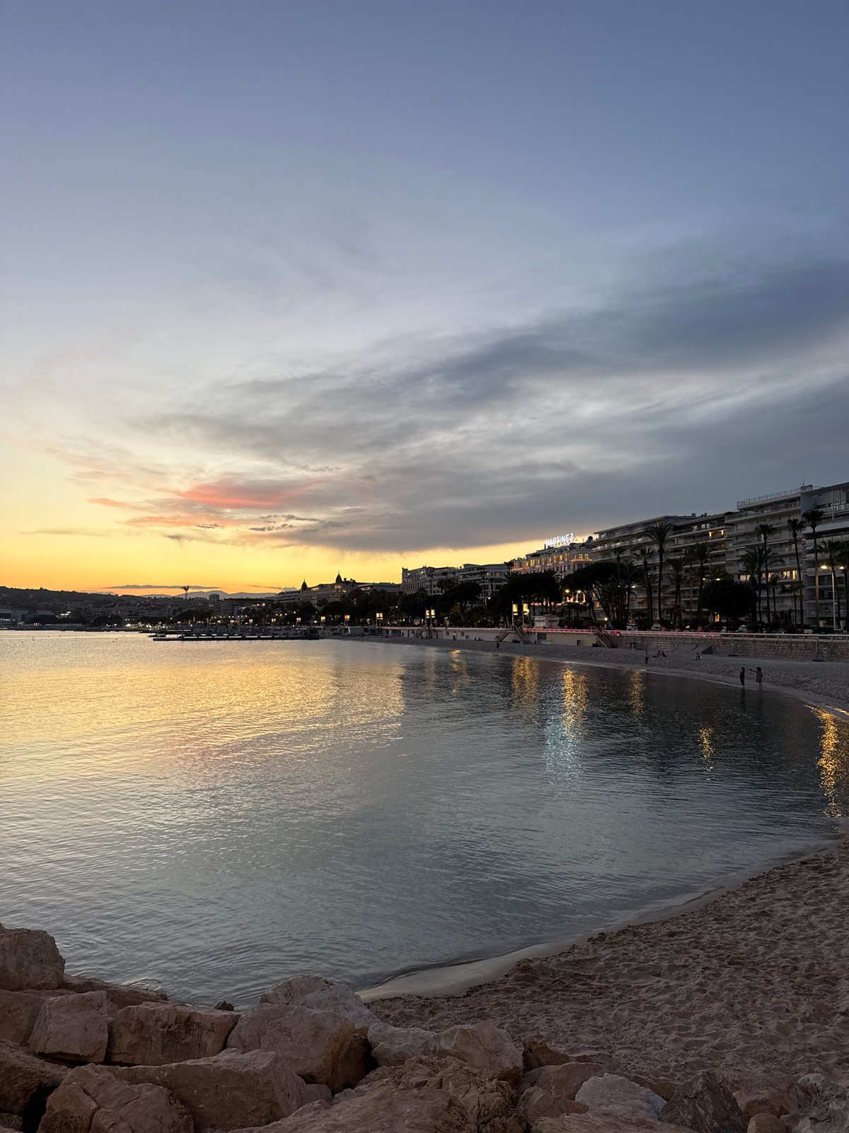 Cannes waterfront at dusk, from beach bars to marina
