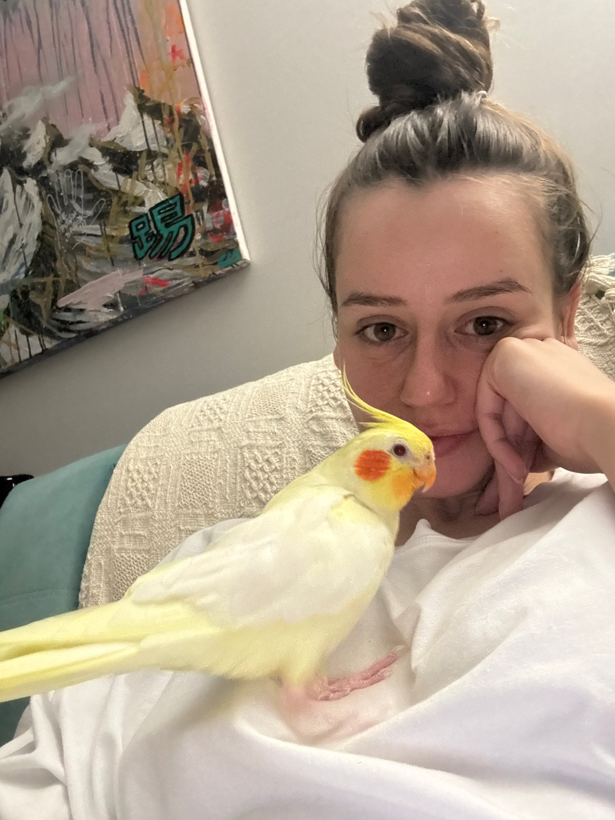 Woman poses with pet cockatiel in Krasnoyarsk home