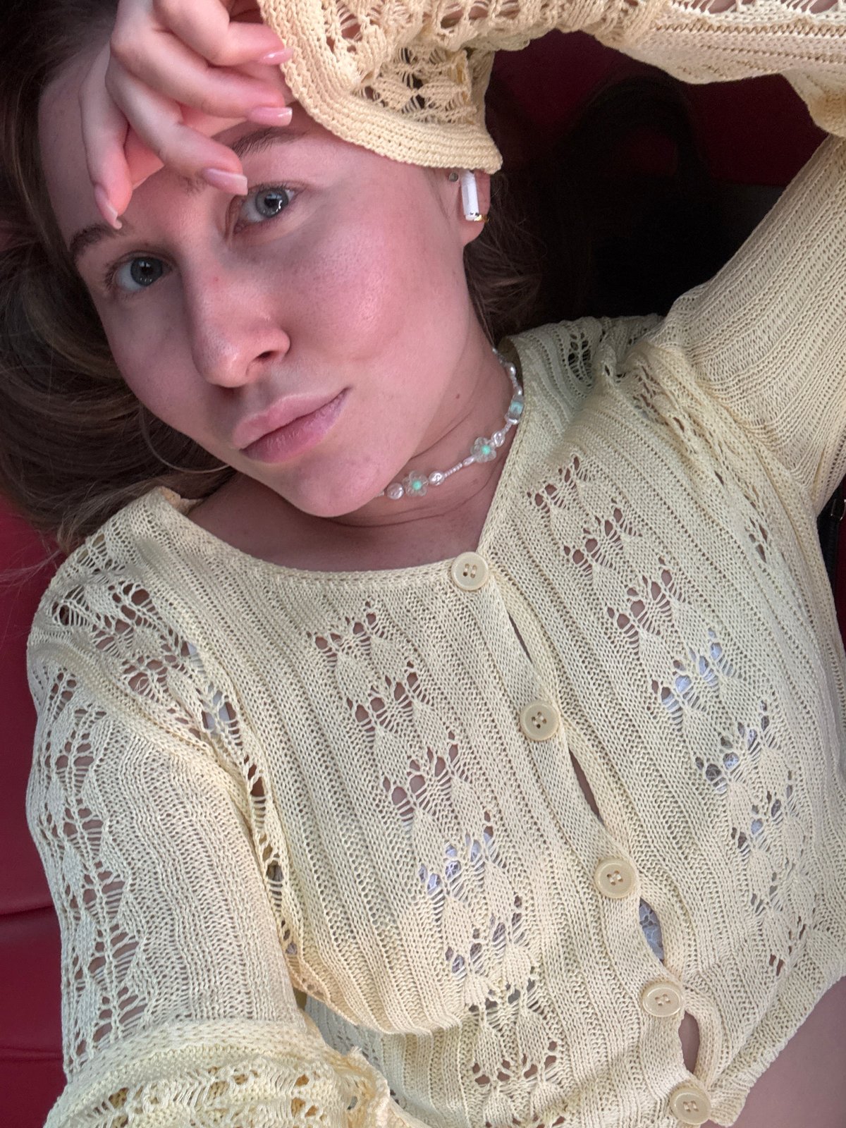 Yellow knit cardigan and pearls, shot from above in Fuyang