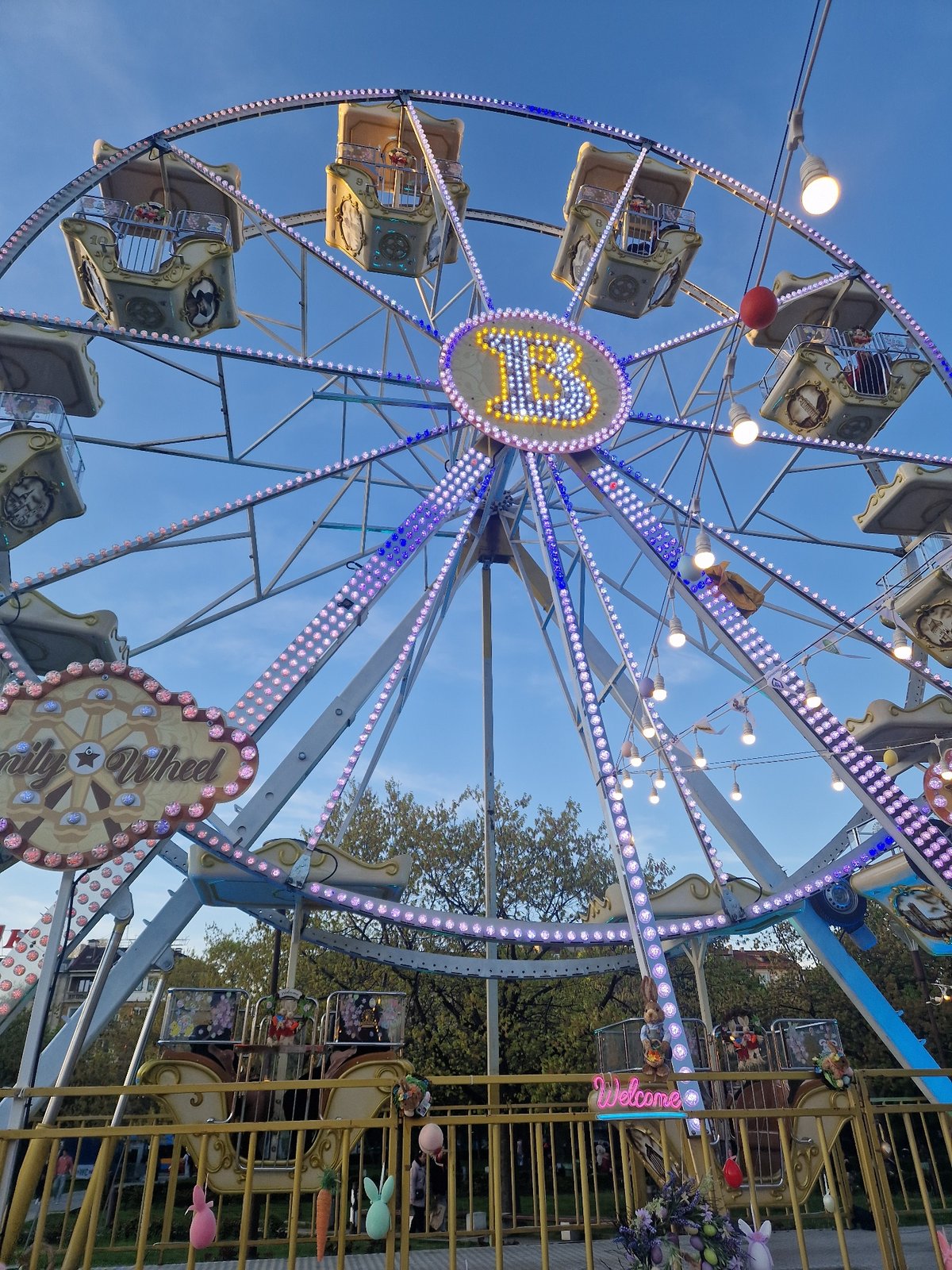 Evening carnival draws crowds to public square during golden hour