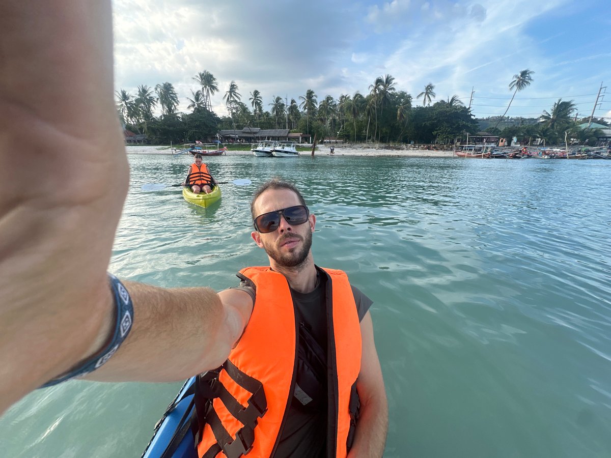 Kayaks and longtail boats on a cloudy Ko Samui morning