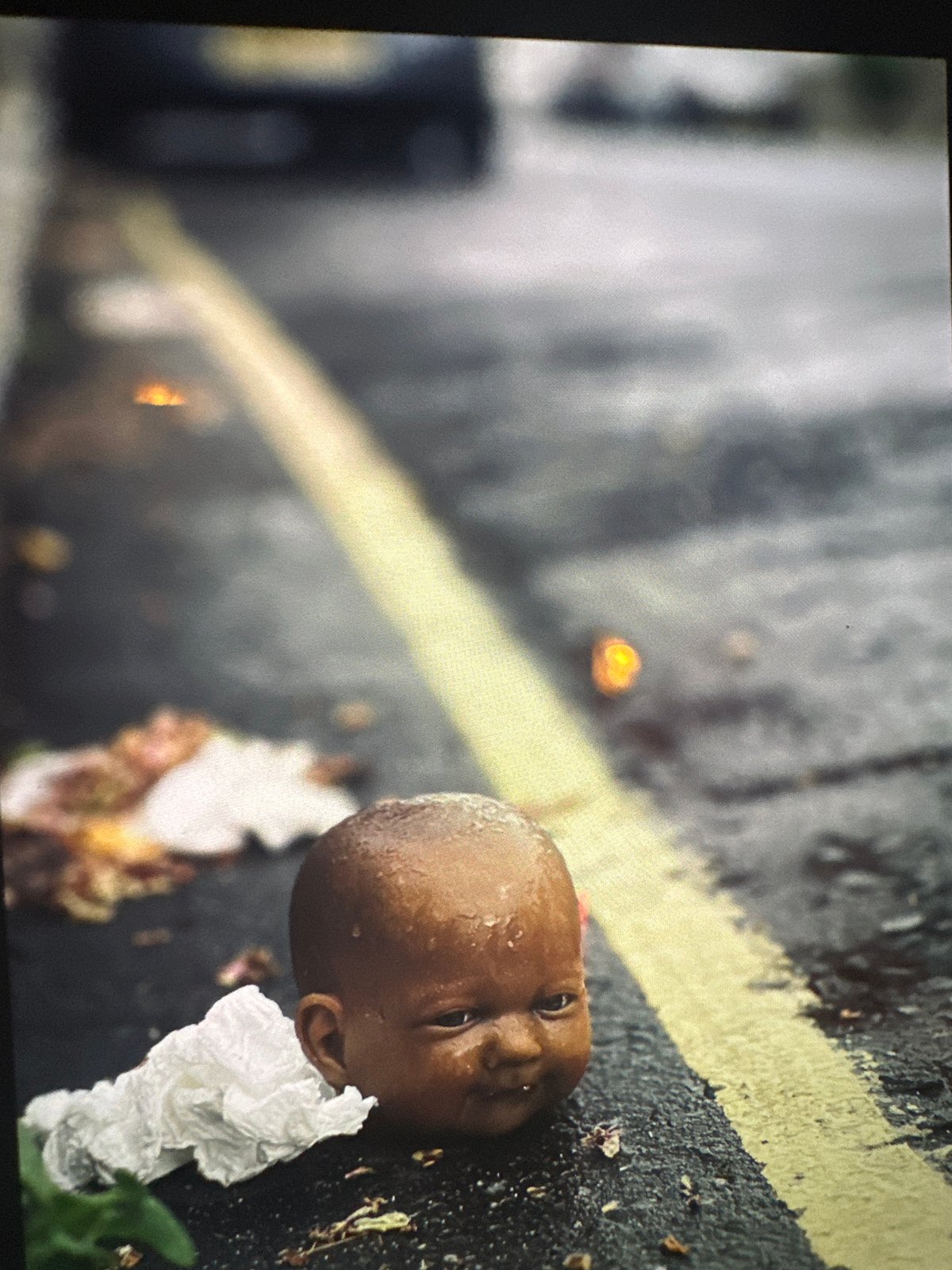 London evening scenes: discarded doll, man at table