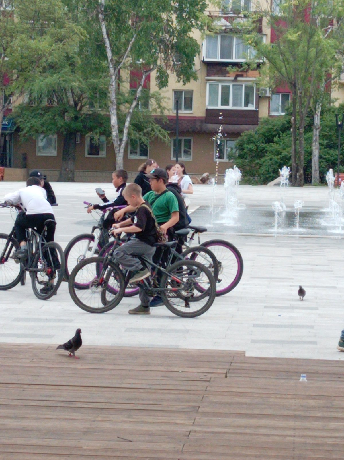 Young cyclists gather at fountain in Artyom square