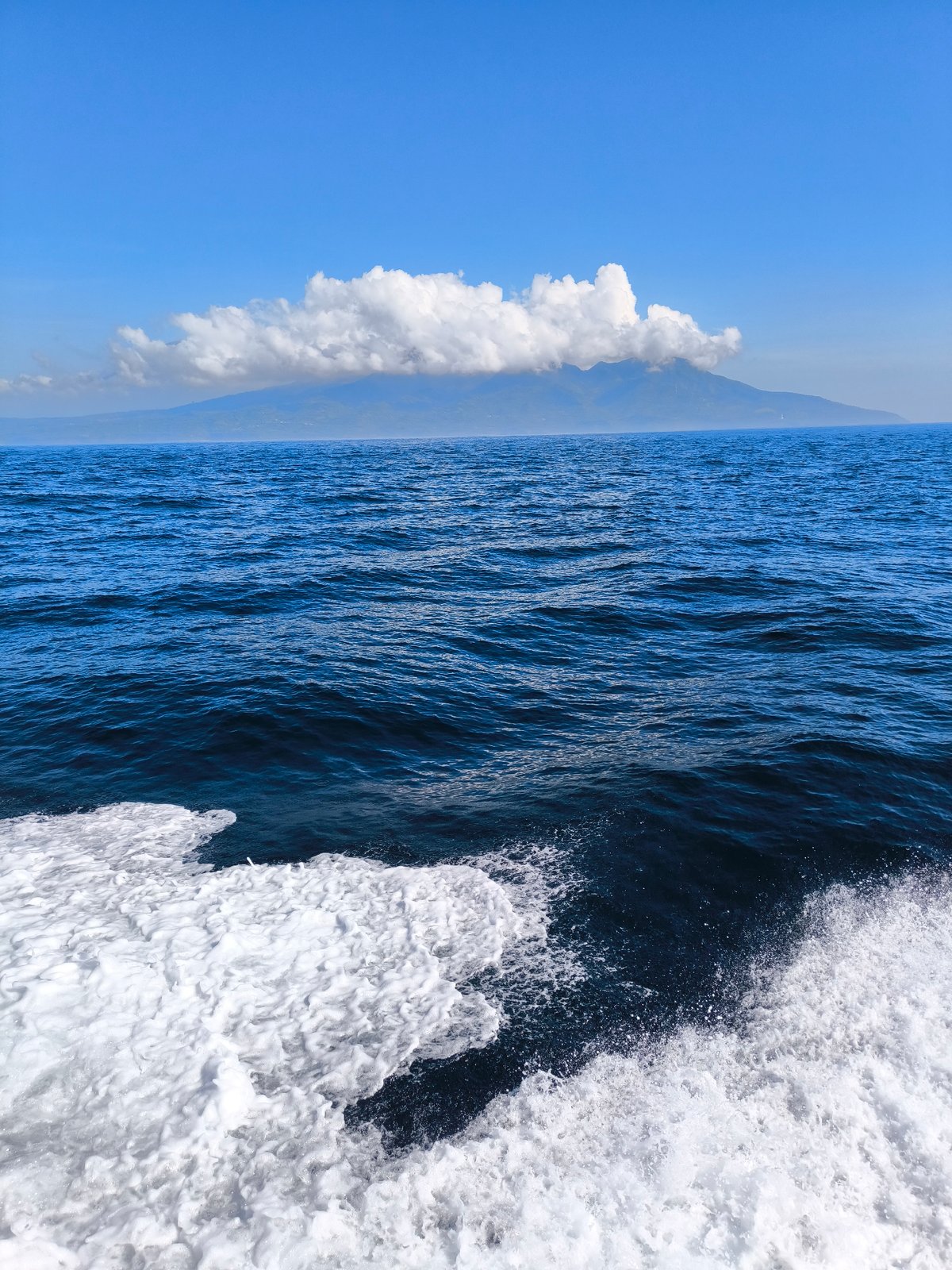 Ocean waves and mountain landscape observed in Indonesia