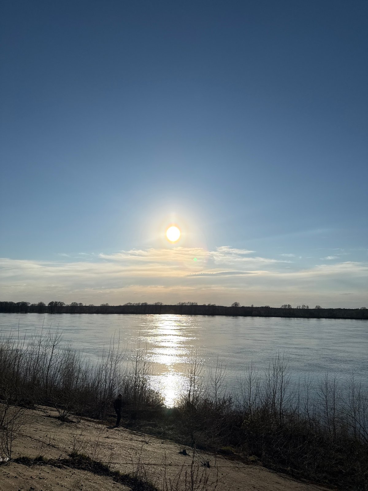 Sunlit riverside scene captured in Chaikovsky, Russia