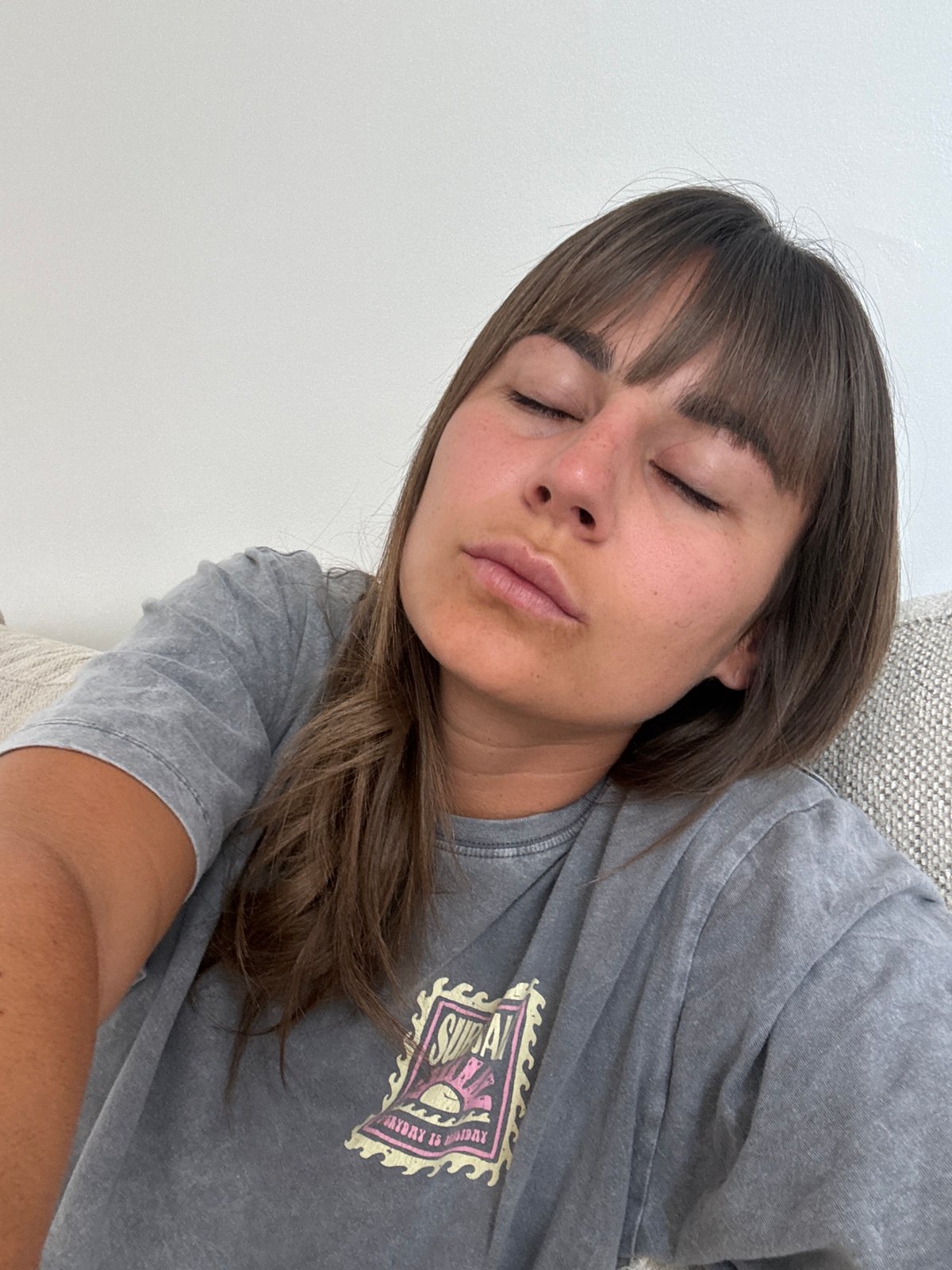Woman rests peacefully on sofa in Cannes residence