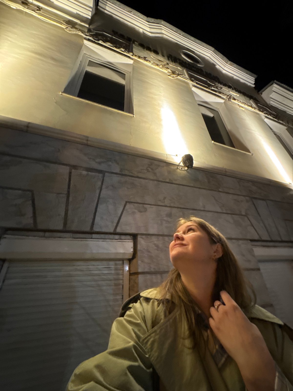 Woman photographed against illuminated building in Perm