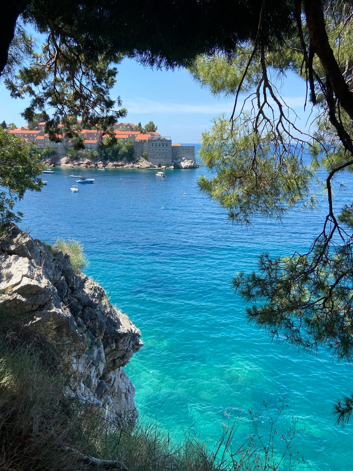Tourist documents scenic views of Montenegro's Sveti Stefan resort island