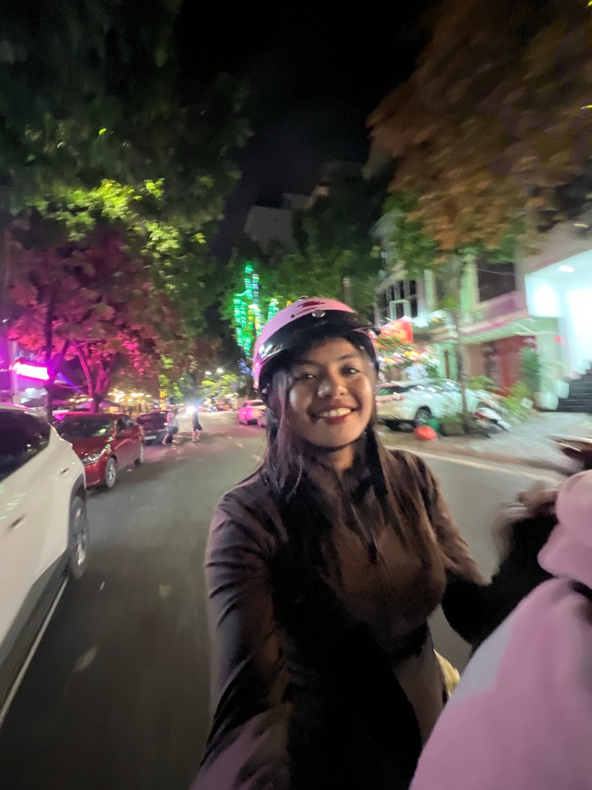 Late-night motorcycle selfies on wet streets in Minh Xuân Ward