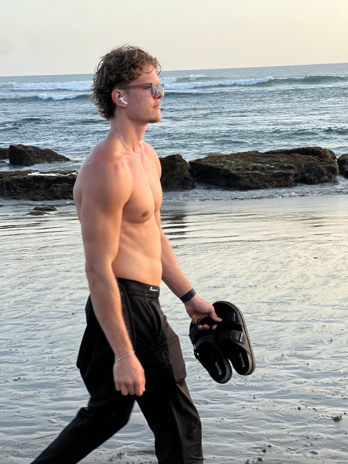 Kuta Beach in full swing: surfers, corn vendors, and shoreline strollers
