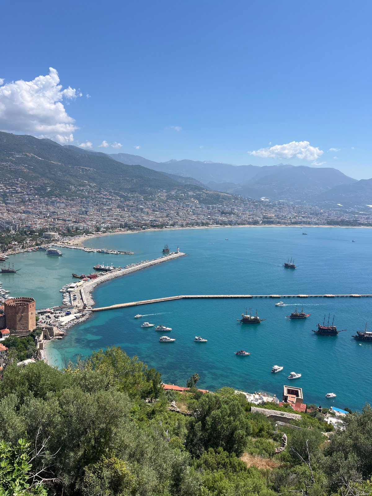 Aerial views capture Alanya Turkey coastline and harbor activity