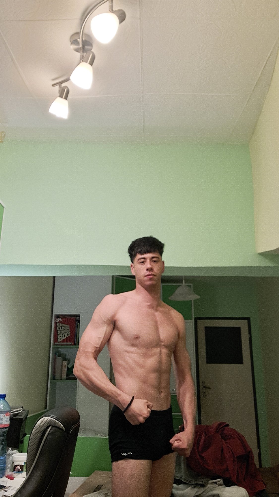 Young man films fitness poses indoors in Burgas