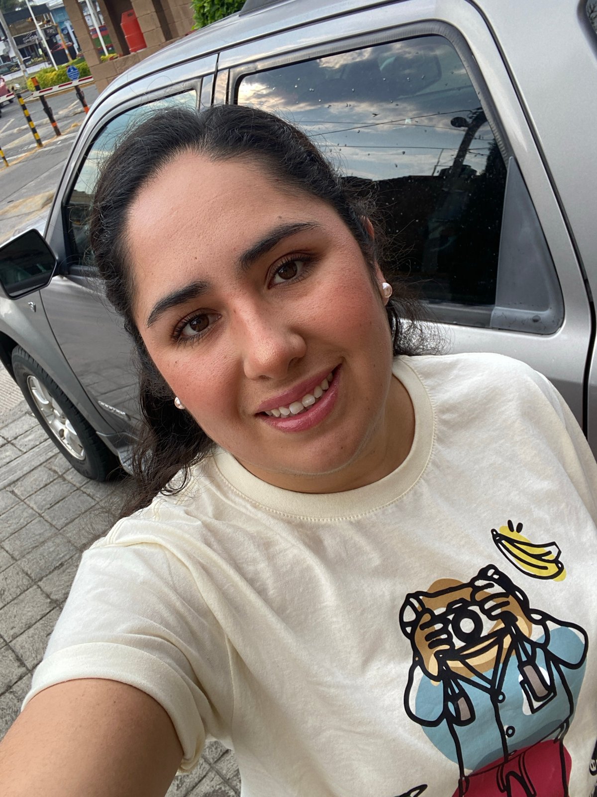 Woman photographed smiling on street in Tlaxcalancingo, Mexico