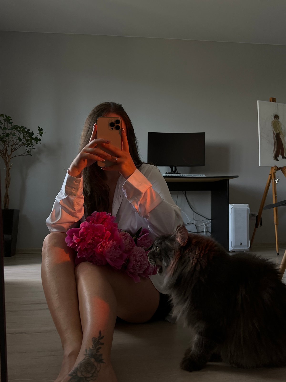 Woman takes selfies with pink peonies in Ternopil home