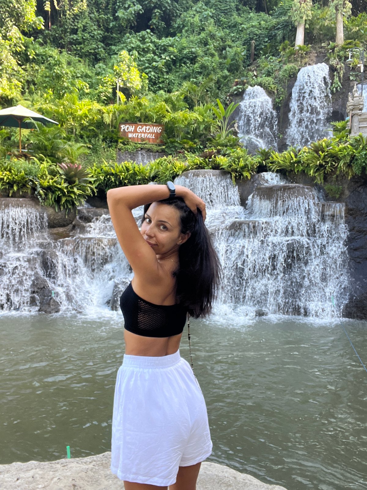 Tourist visits Poh Gading Waterfall in Sukawati, Indonesia
