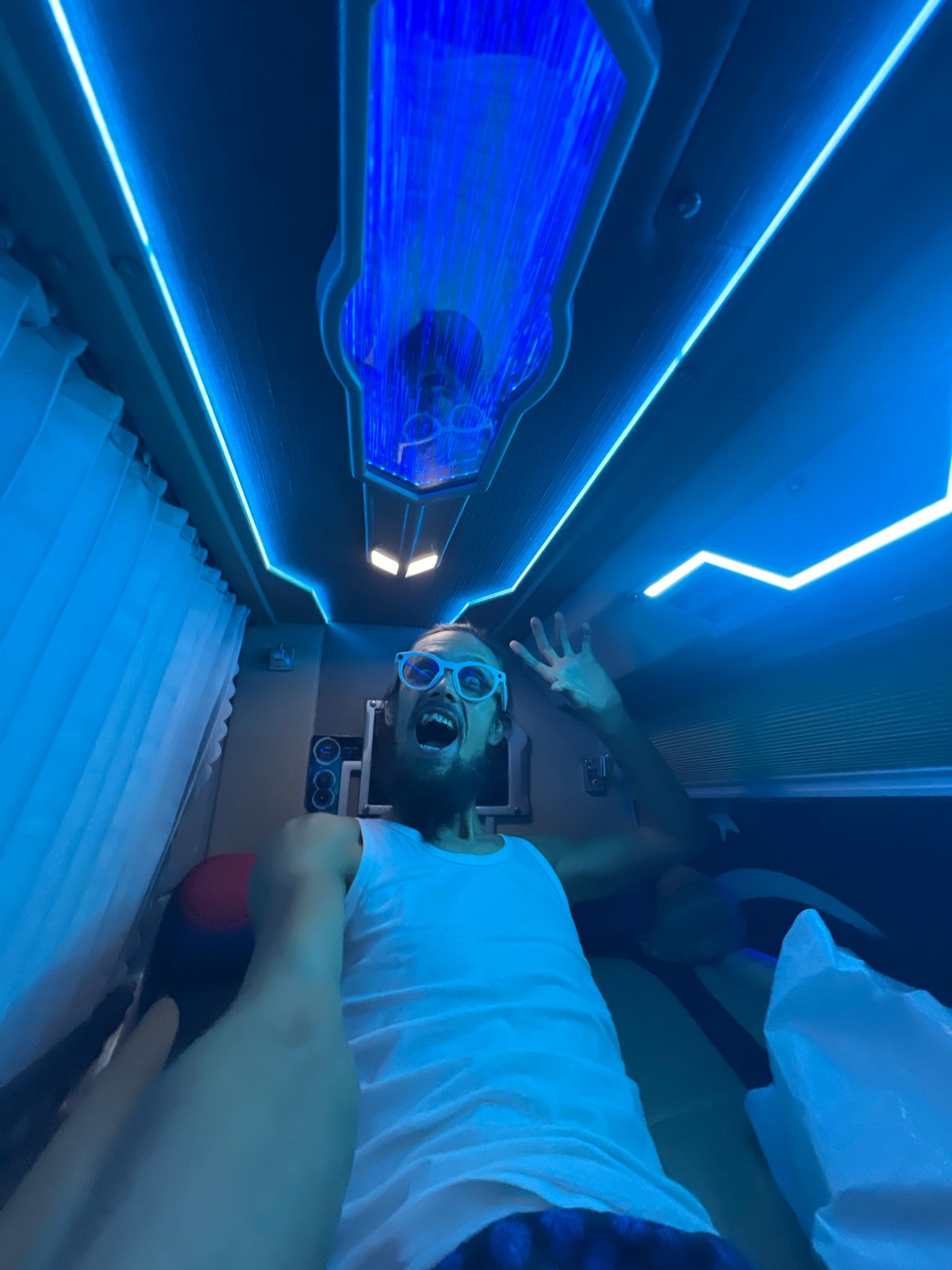 Selfie clips inside a neon-lit capsule pod