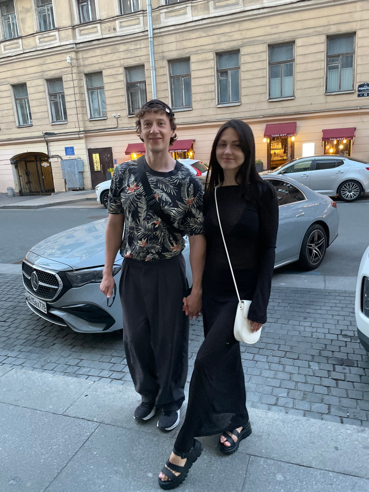 Tourists explore Saint Petersburg landmarks during summer evening hours
