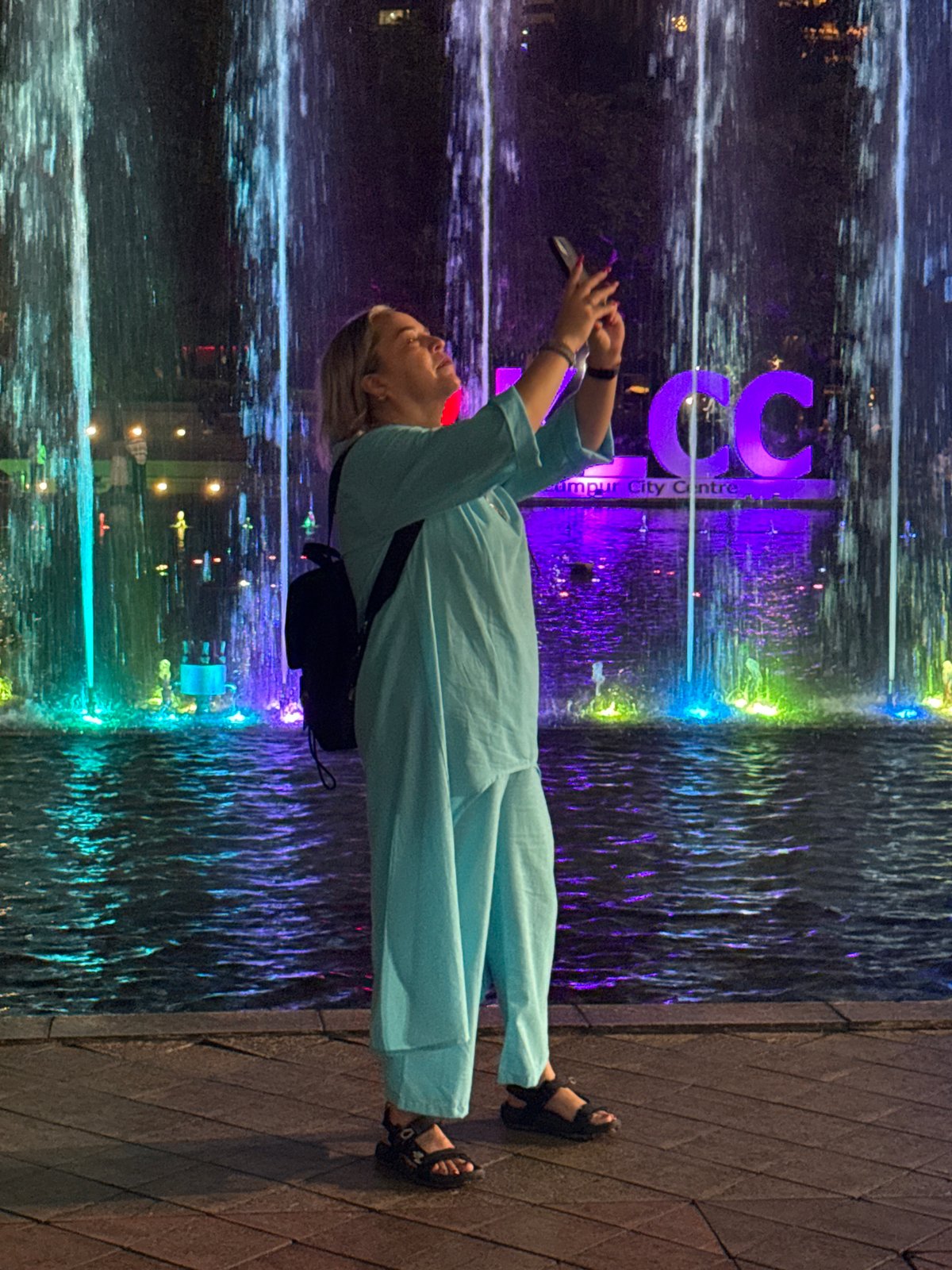 Woman photographed by illuminated water feature in Kuala Lumpur
