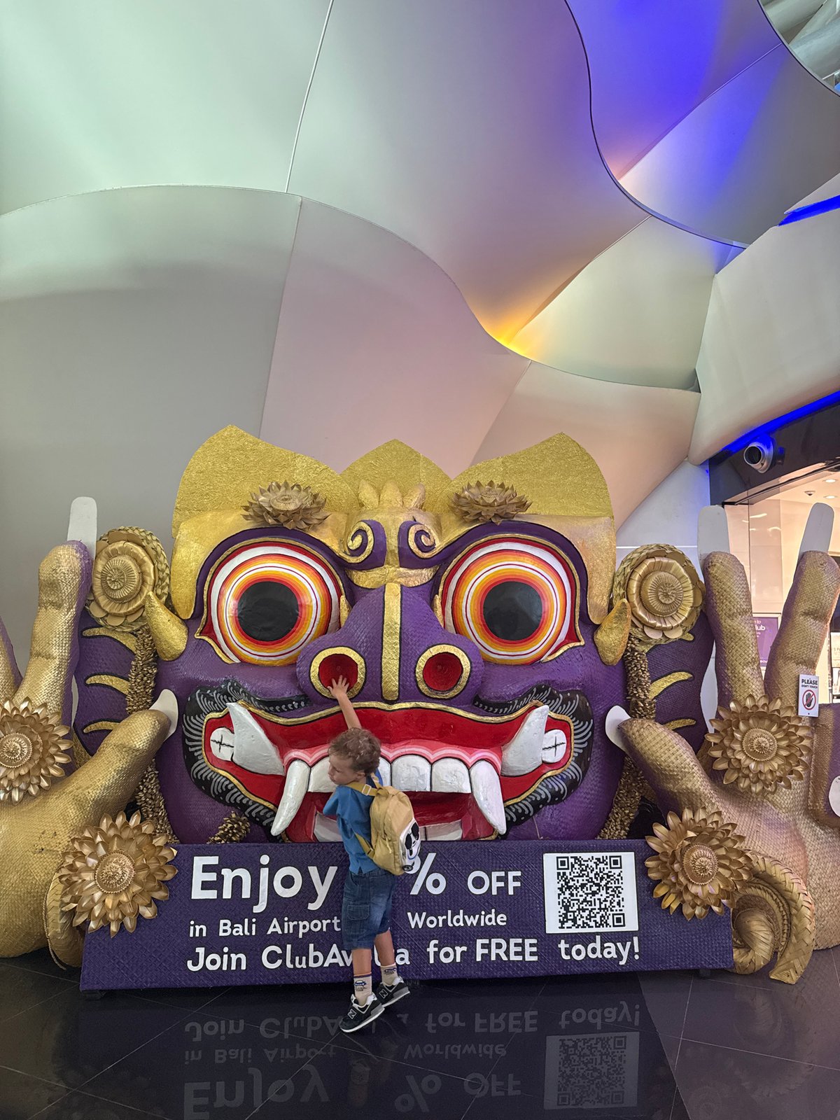 Balinese masks and temple art fill Kuta's airport departure halls