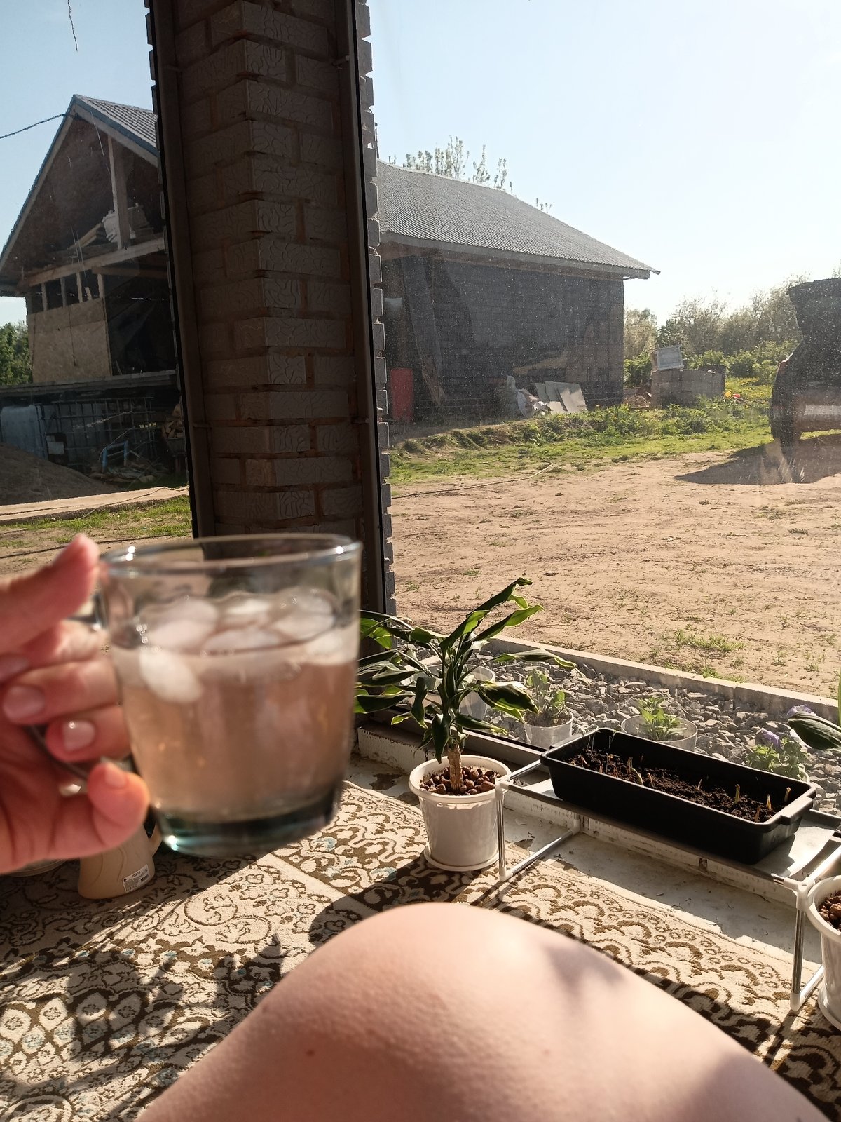 Woman photographed with iced drink in rural Russian village