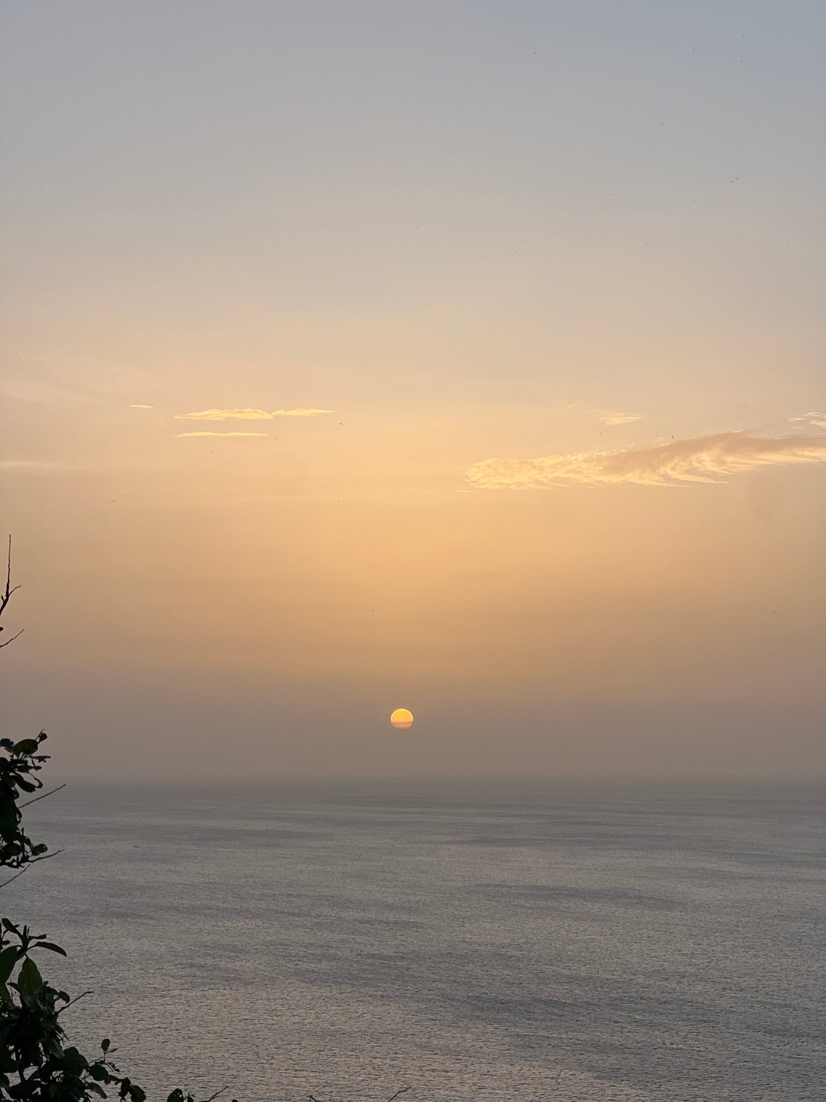 Sun sets and moon rises over San Juan del Sur