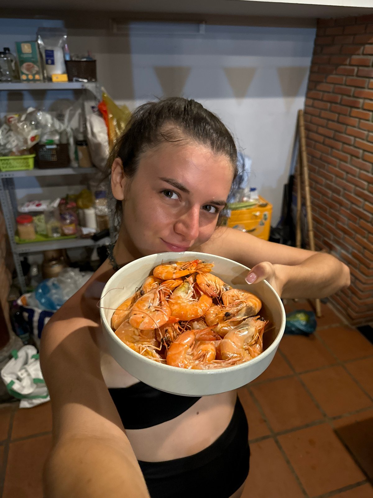 Woman poses with shrimp bowl in Mũi Né kitchen