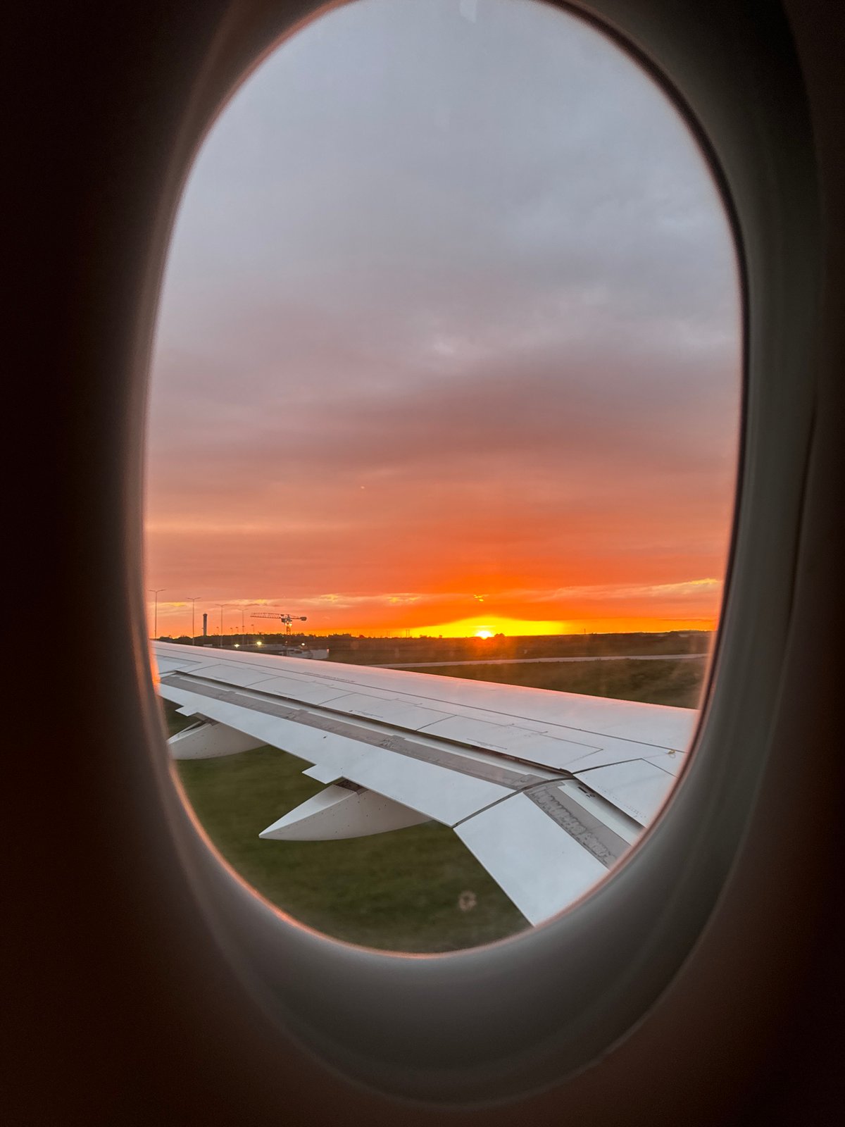 Passenger captures sunset view from airplane window over France