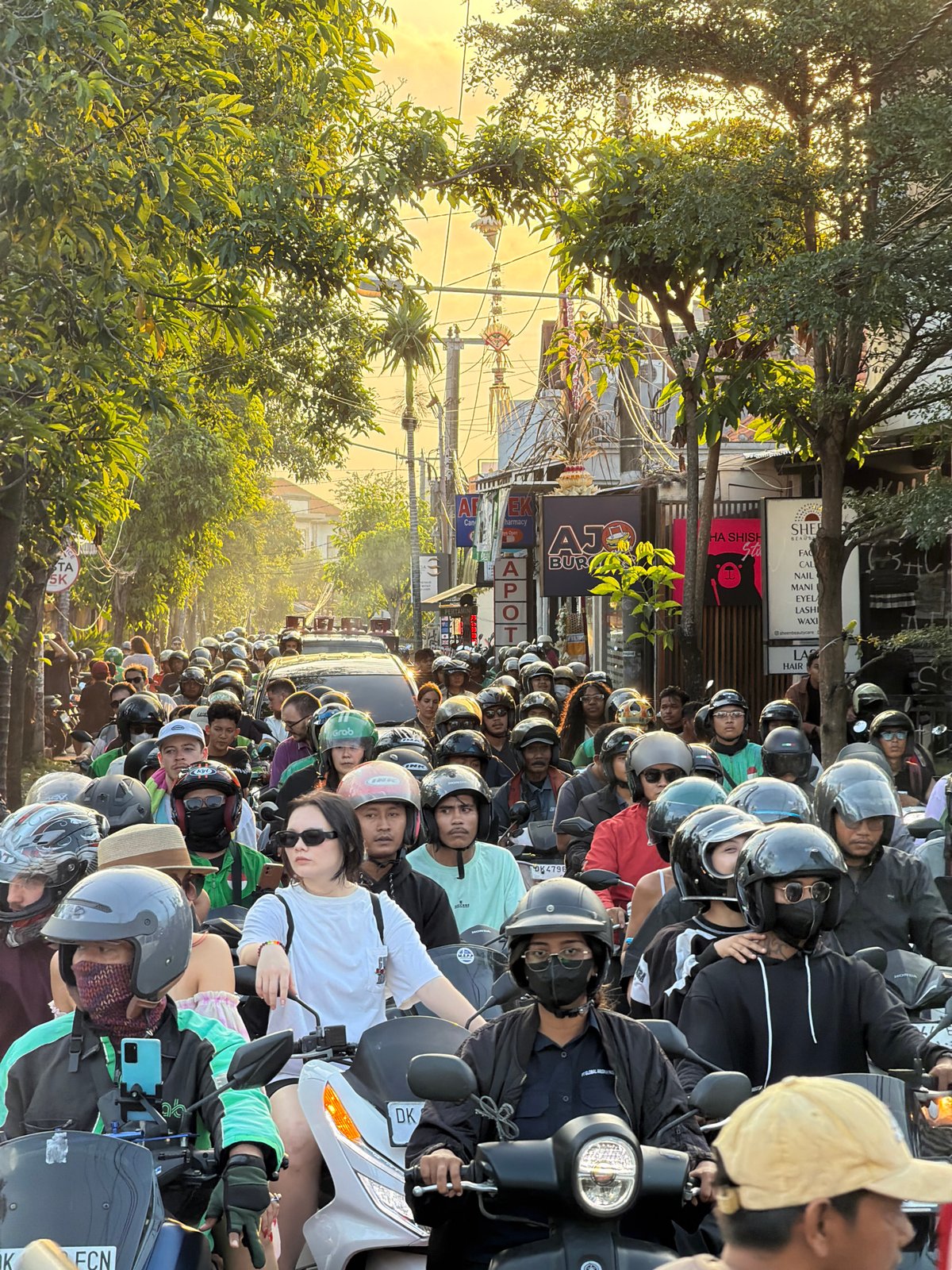 Dense motorcycle traffic clogs a North Kuta street