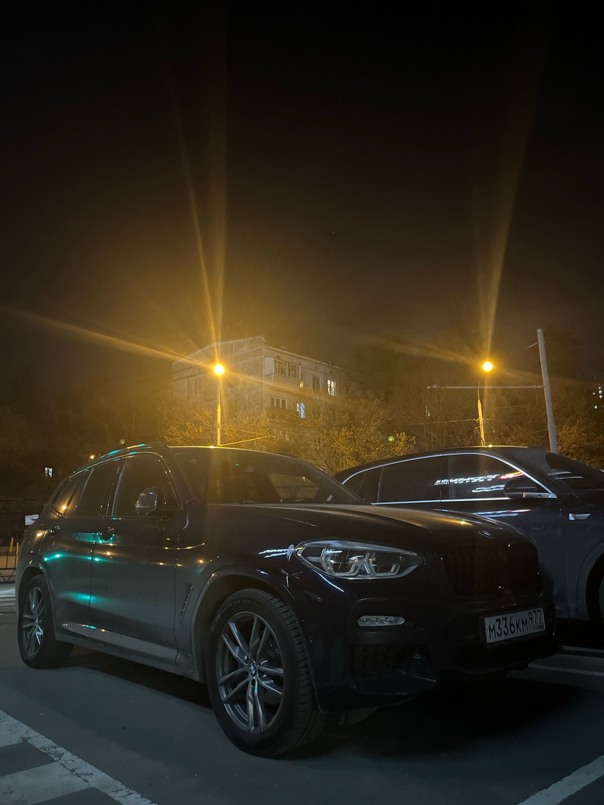 Nighttime luxury vehicles and hotel documented in Moscow
