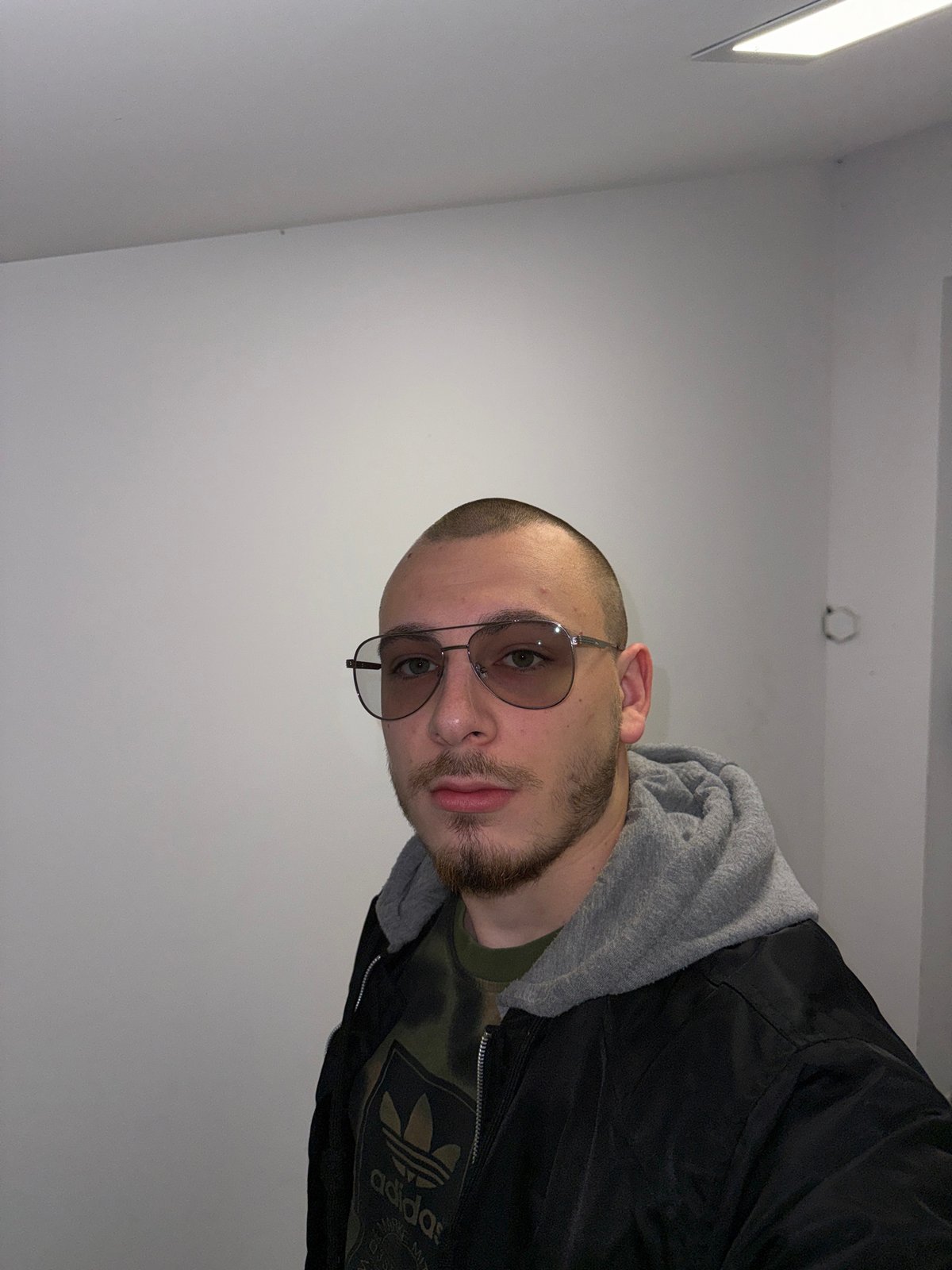 Man in Adidas jacket photographed indoors in Bulgaria