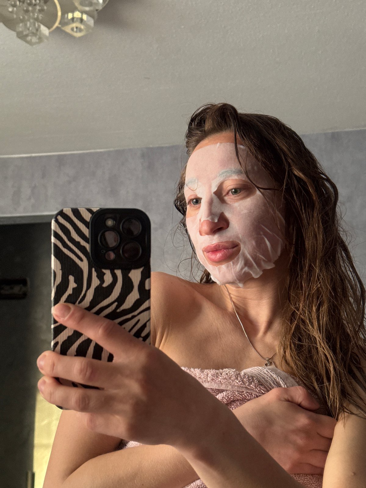 Woman documents skincare routine with dog in Chaikovsky home
