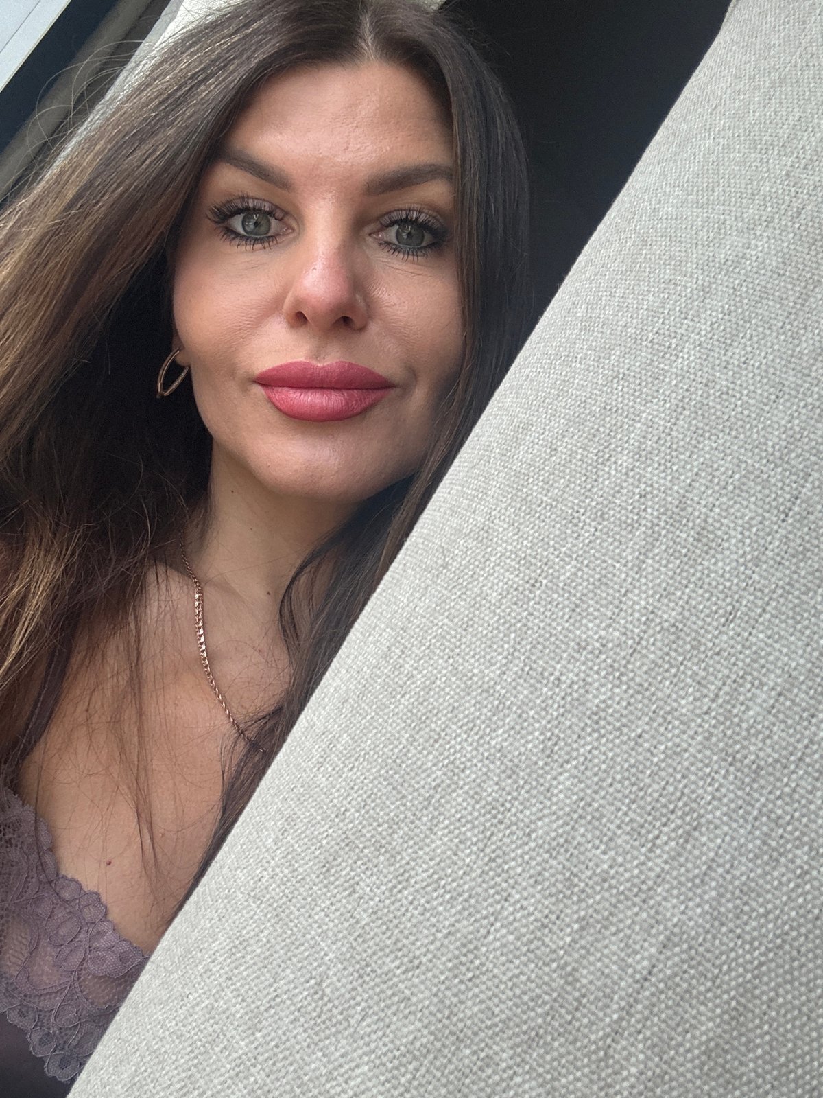 Woman takes multiple selfie portraits with cat in Chaikovsky