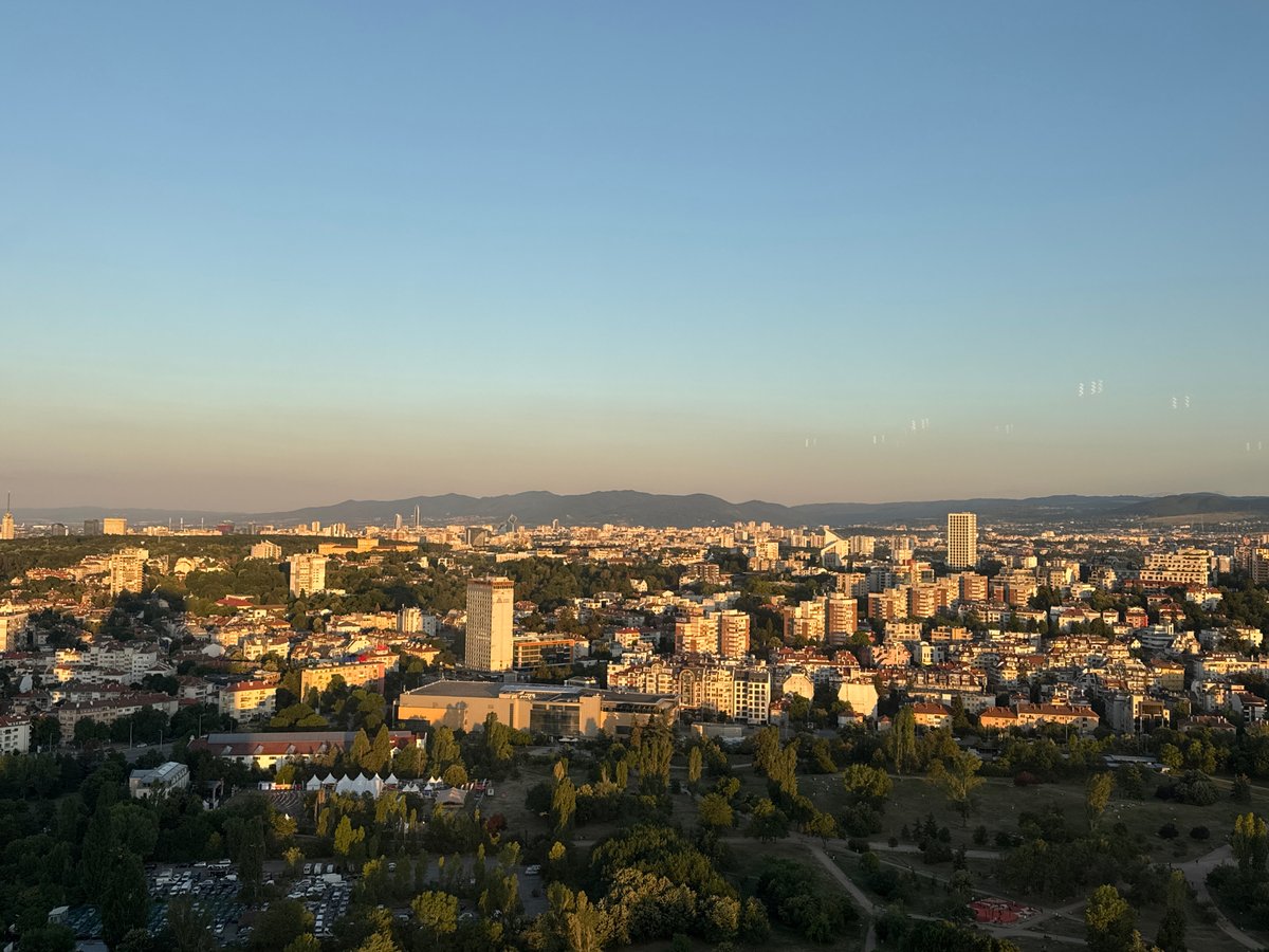 Golden-hour Sofia rooftop dining with city views below
