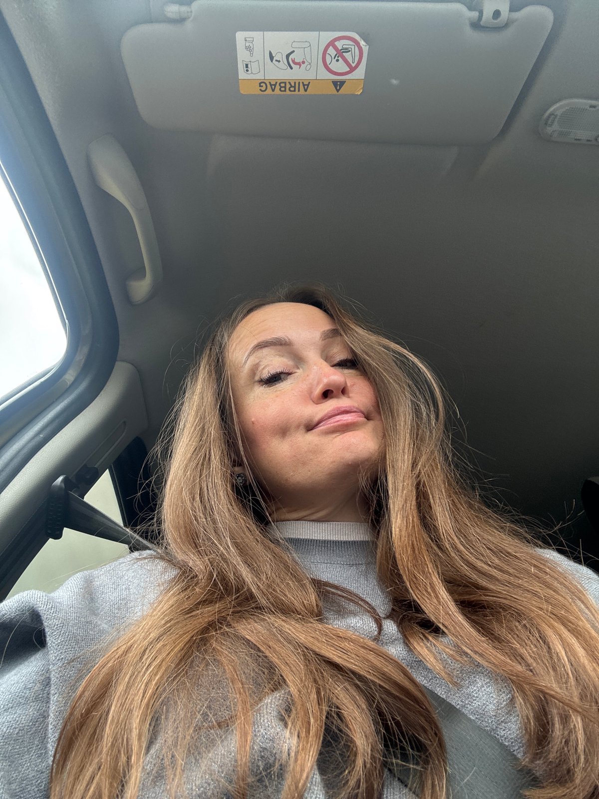 Woman photographed inside vehicle in Povarёnki, Russia