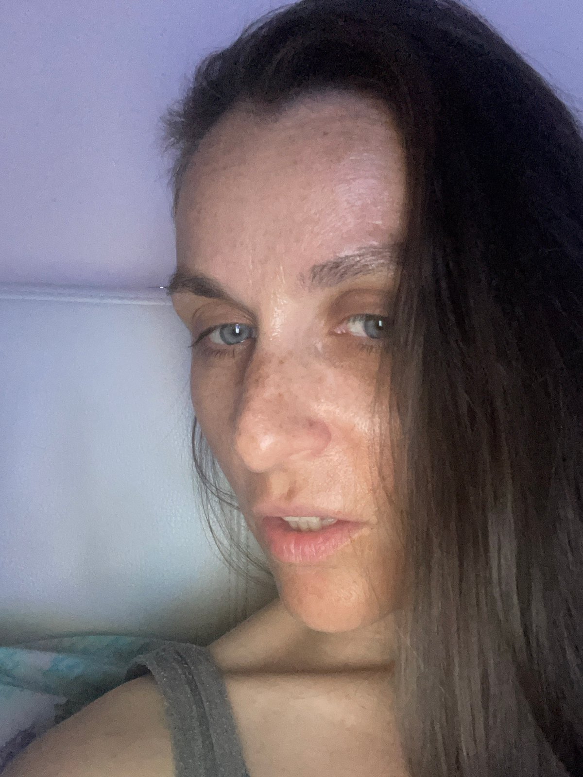 Relaxing at home with a blanket and TV remote