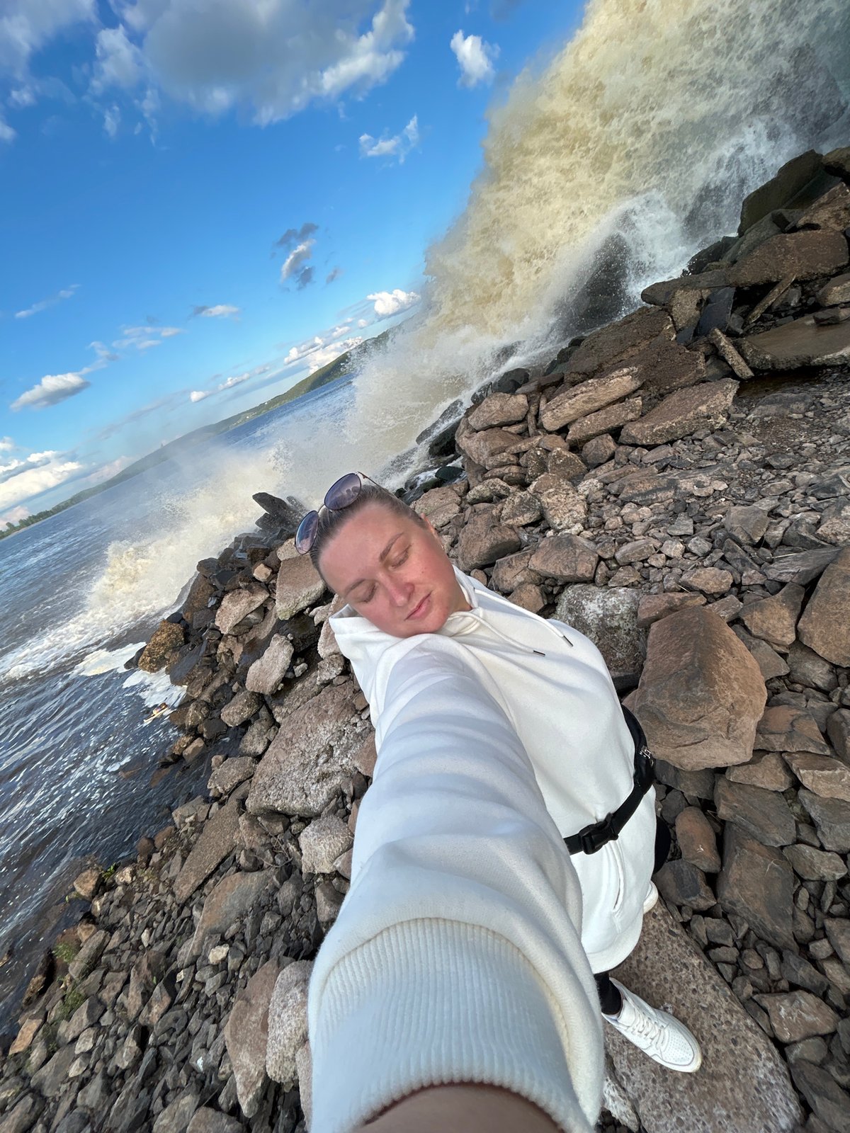 Woman takes selfies by turbulent waters in Chernushka, Russia