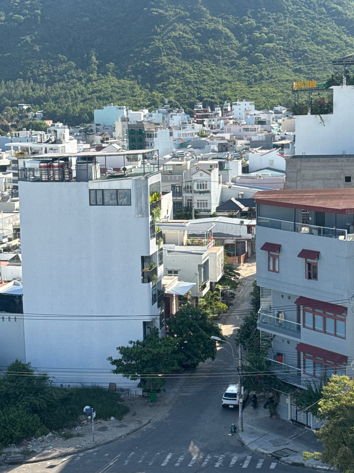 Nha Trang cityscape morning: construction smoke, hills, and street life