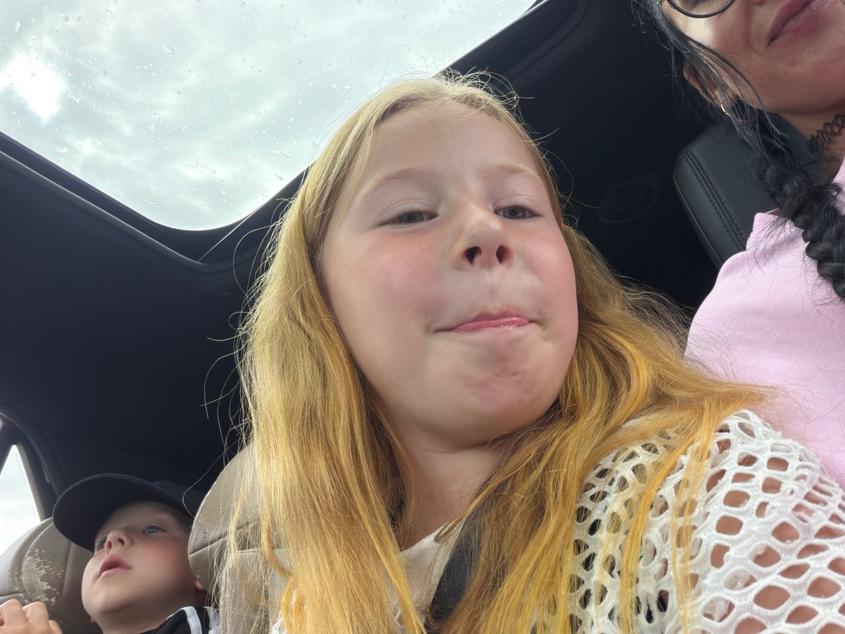 Cloudy day car ride in Шолохово, sunroof open, lollipop in hand