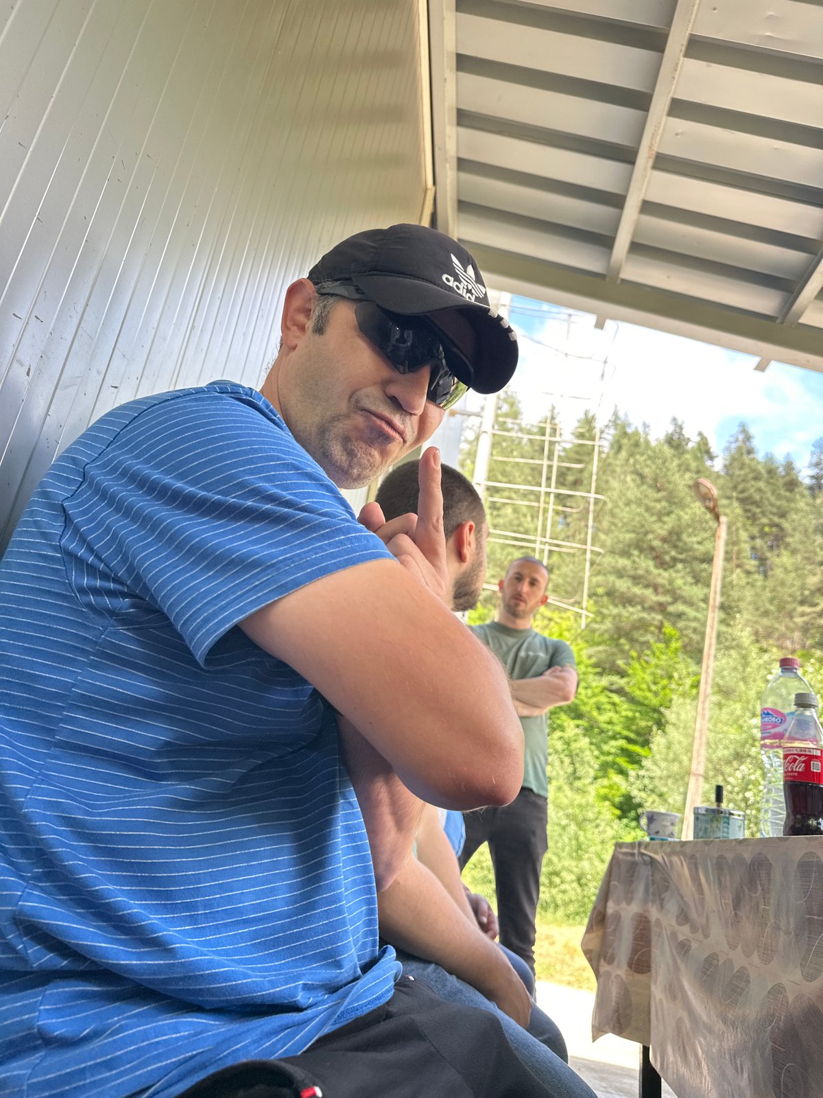 Man in Adidas cap spotted under metal roof in Smolyan