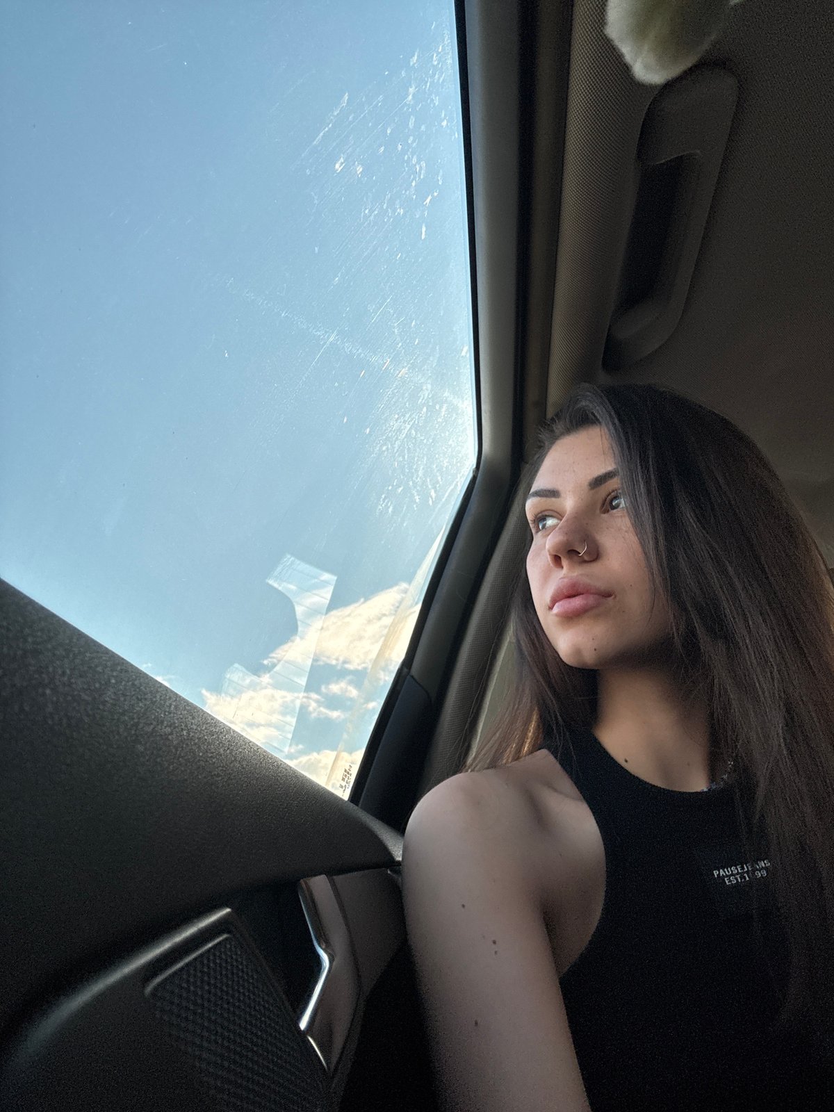 Woman photographed looking out car window in Voluyak, Bulgaria