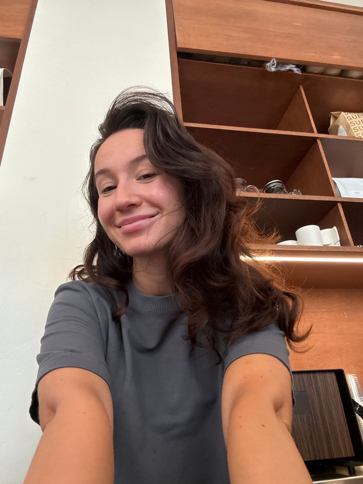 Casual indoor portrait in front of a wooden shelf, Tel Aviv