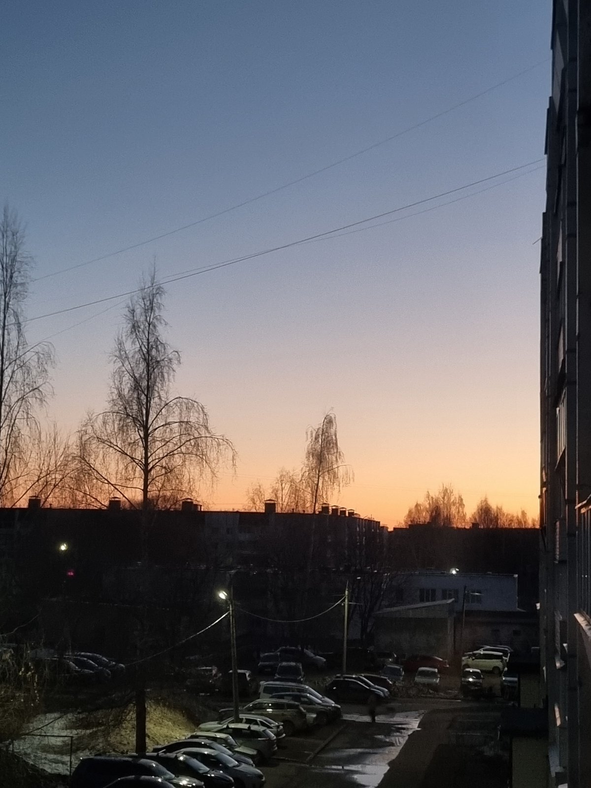 Twilight gradient sky photographed between apartment buildings in Chaikovsky