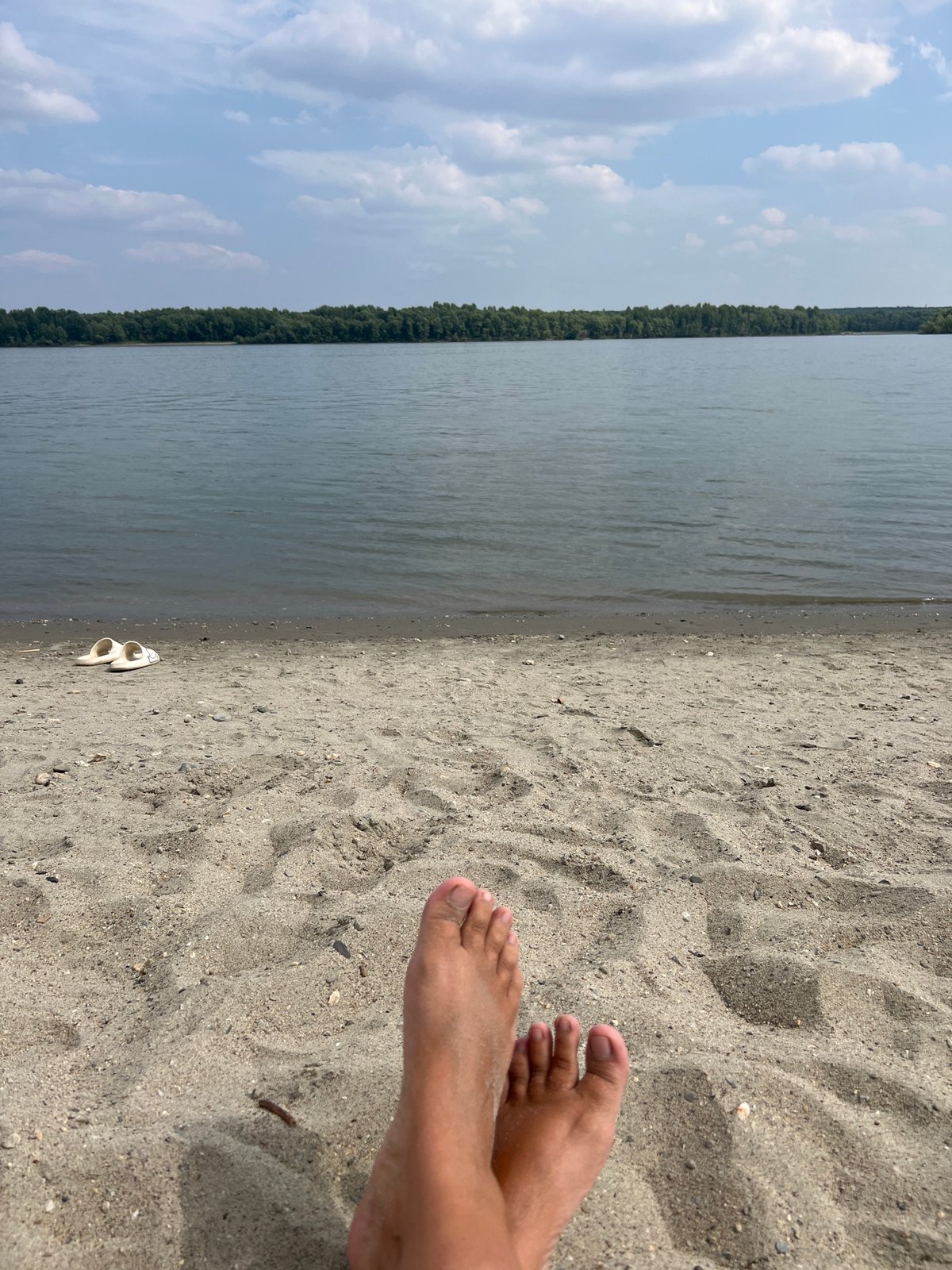 Lazy summer morning on the river beach in Mochishche