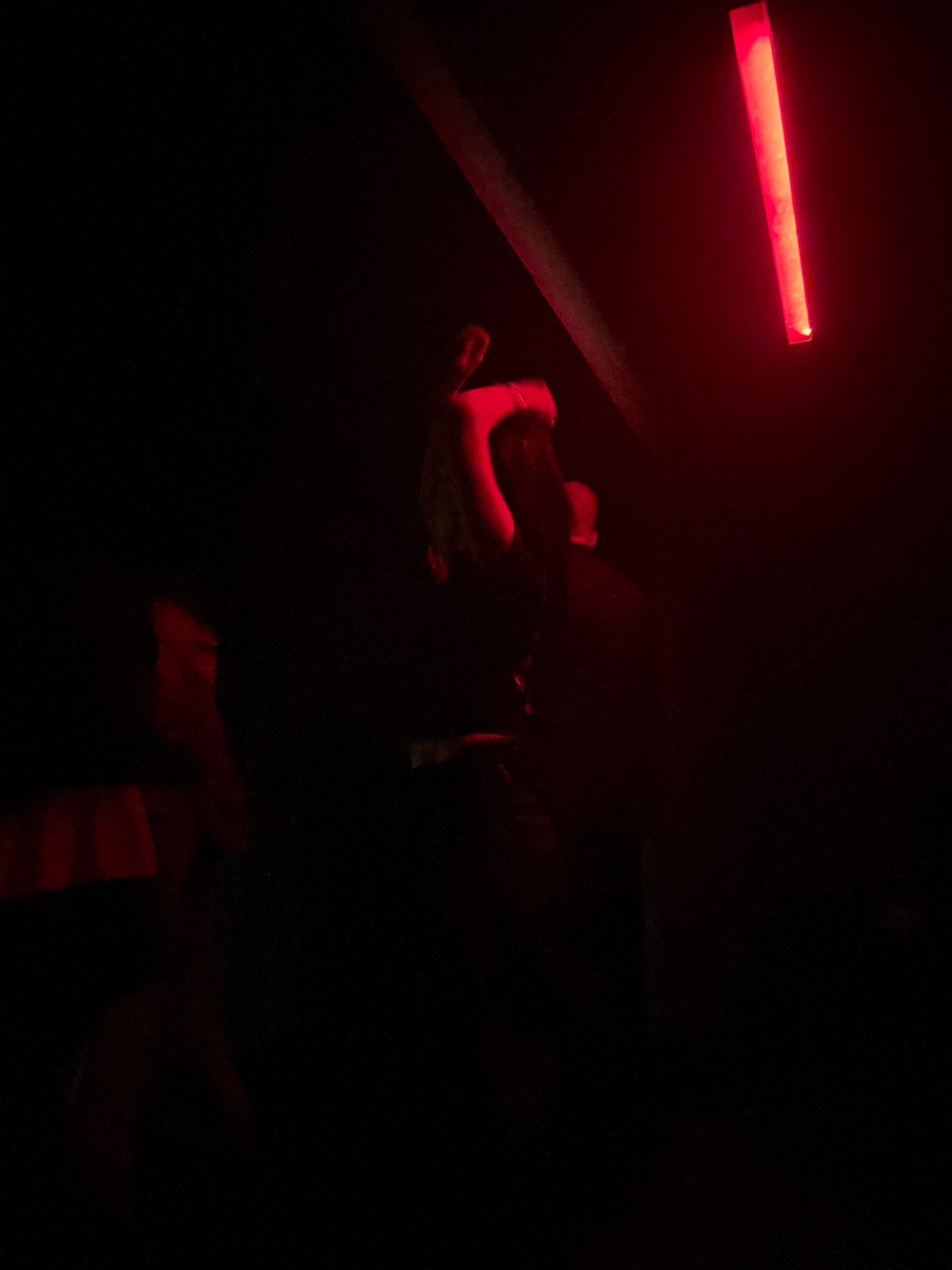 Nighttime gathering captured in red-lit venue in Tbilisi