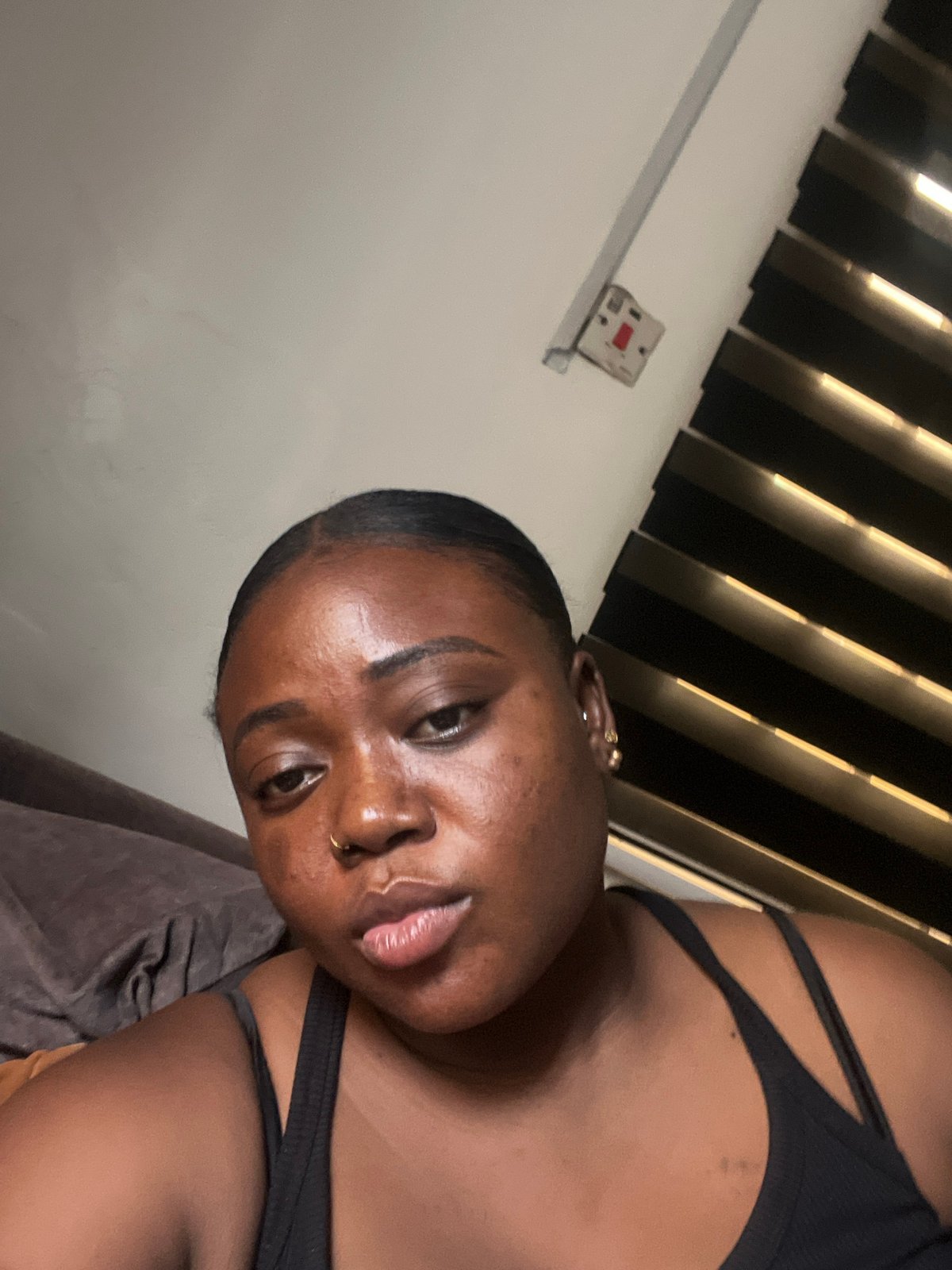 Woman documents casual phone time during indoor photo session