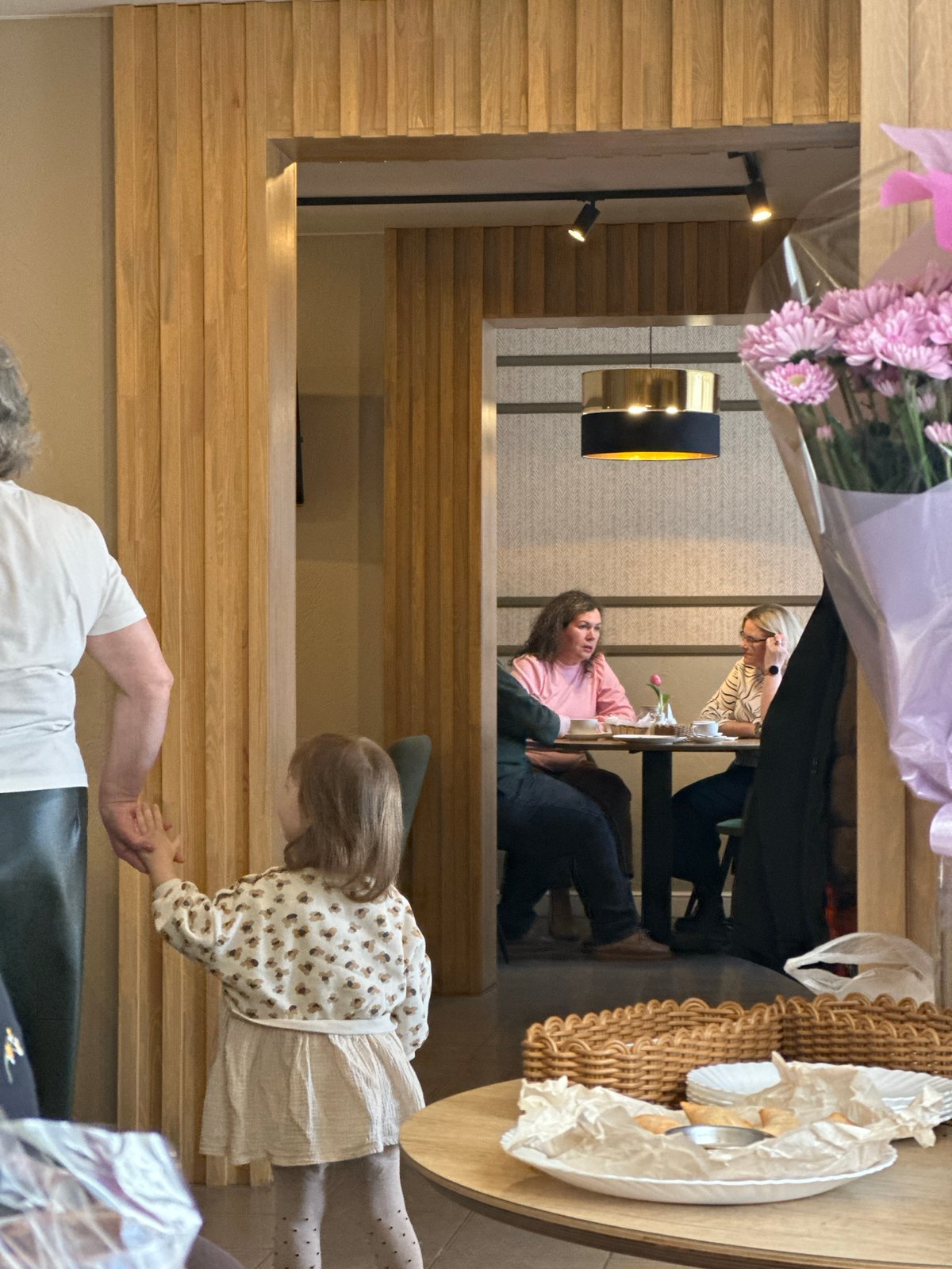 Two women dine at Dobryanka restaurant with pink flowers