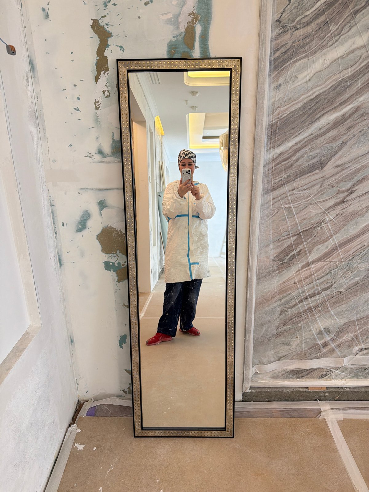 Person in protective suit takes mirror selfie in Khimki